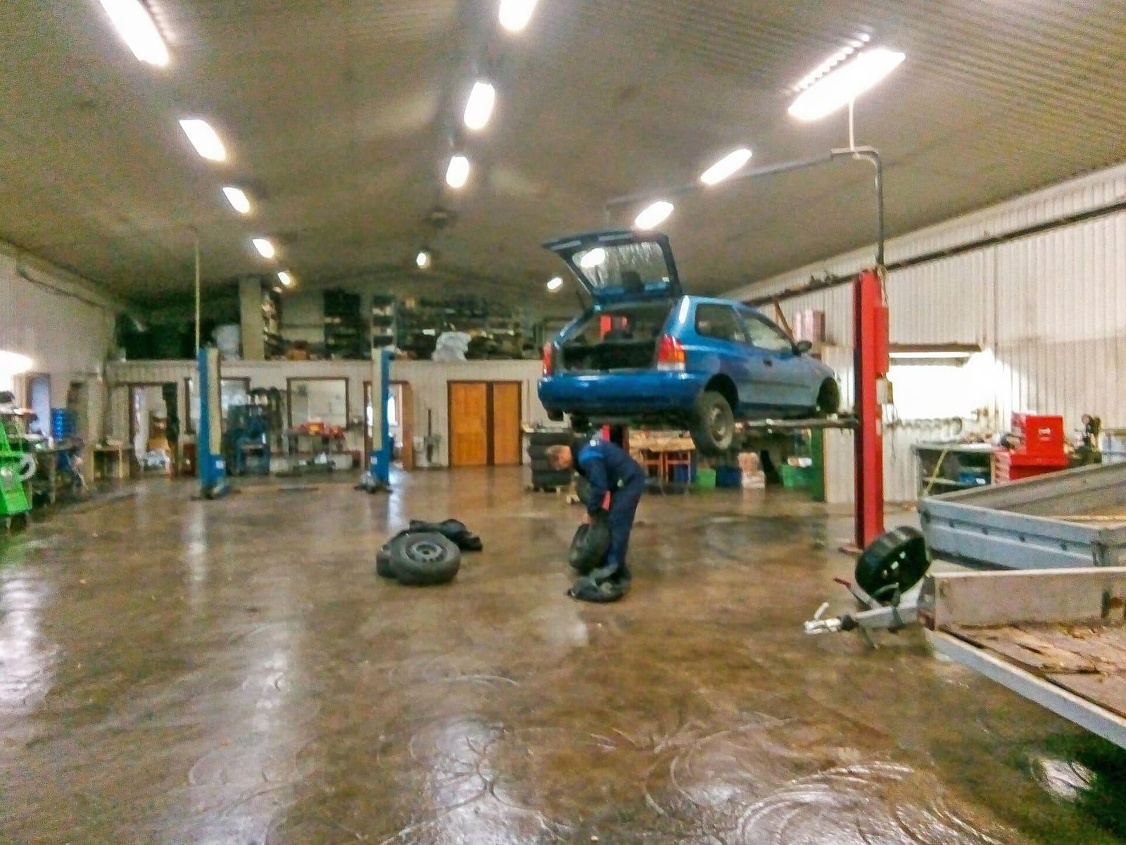Vehicle being serviced on a lift in a repair workshop