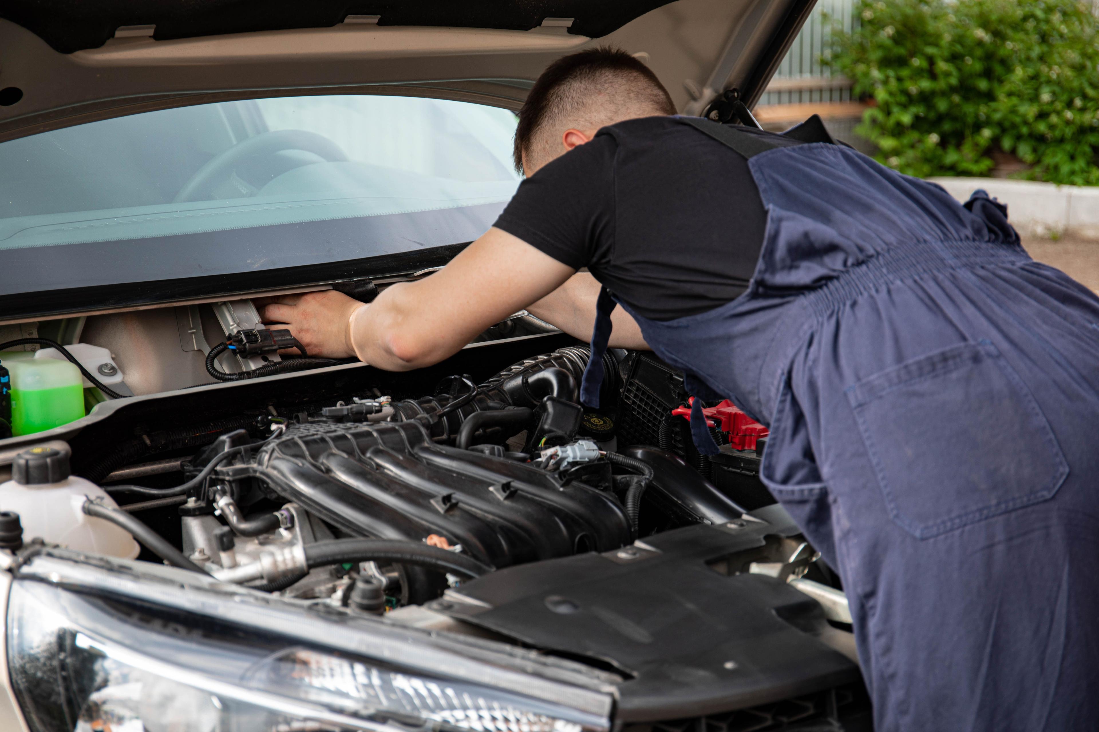 Nissan Patrol Battery technician testing a battery in Dubai